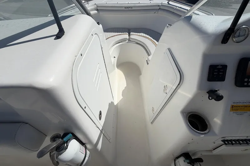 Slide: The Image of 2008 Sea Fox 216 Dual Console interior with storage compartments and control panel. - 29