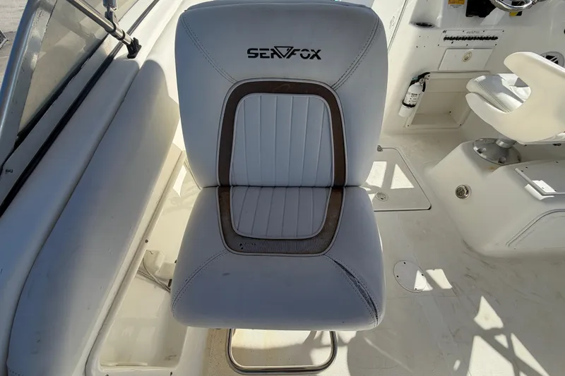 Slide: The Image of 2008 Sea Fox 216 Dual Console boat seat, white with brown accents. - 20