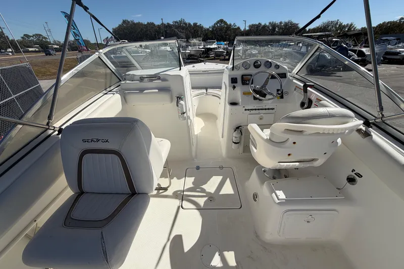 Slide: The Image of 2008 Sea Fox 216 Dual Console boat interior with steering wheel and seating. - 19
