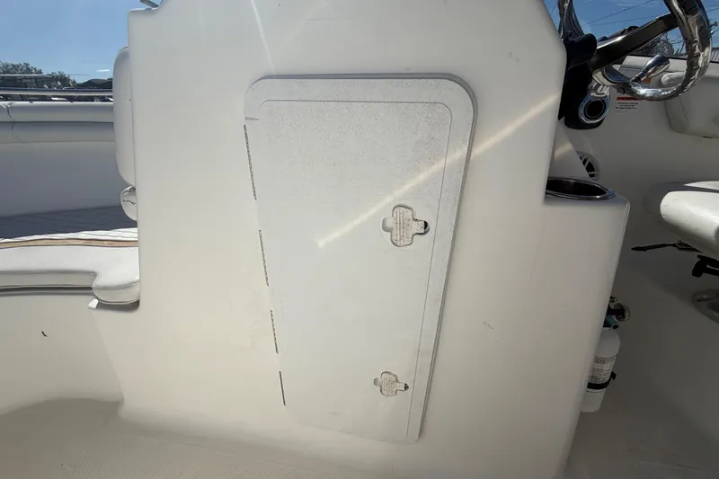 Slide: The Image of 2008 Sea Fox 216 Dual Console interior with storage compartment and steering wheel. - 32