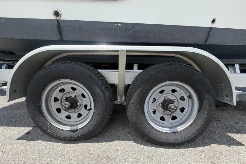 Slide: The Image of Trailer wheels of a 2008 Sea Fox 216 Dual Console boat on pavement. - 56