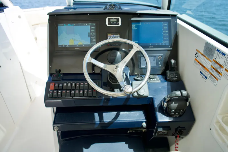 Slide: The Image of Control panel of a 2017 Pursuit DC 325 Dual Console boat with navigation screens. - 18