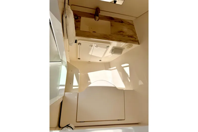 Slide: The Image of 2017 Pursuit DC 325 Dual Console boat interior with sink and storage cabinet. - 28
