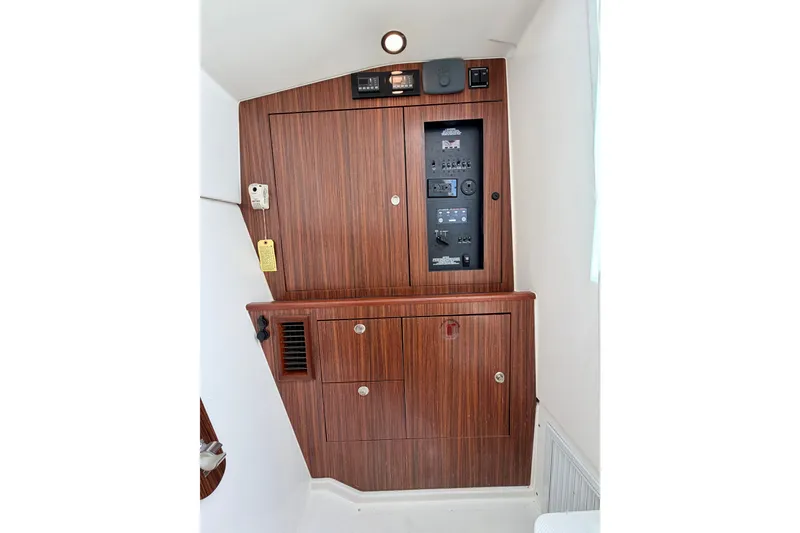 Slide: The Image of 2017 Pursuit DC 325 Dual Console interior with wooden paneling and control panel. - 32