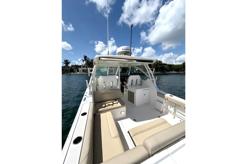 Slide: The Image of 2017 Pursuit DC 325 Dual Console boat on water, clear sky, luxurious seating. - 26