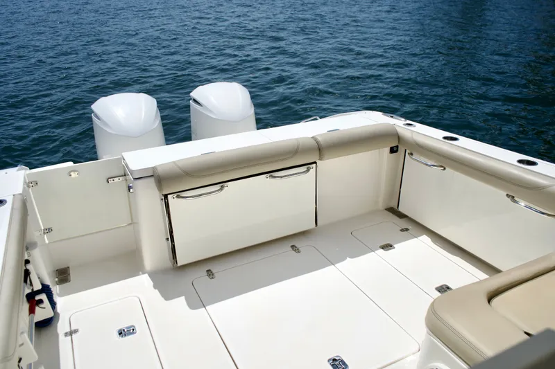 Slide: The Image of 2017 Pursuit DC 325 Dual Console boat with spacious deck and twin engines on water. - 19