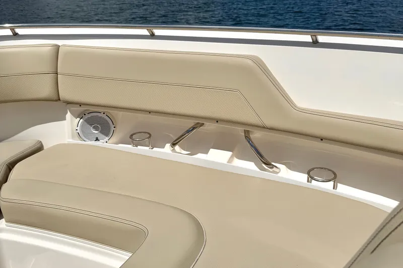 Slide: The Image of 2017 Pursuit DC 325 Dual Console boat interior with beige seating and cup holders. - 30