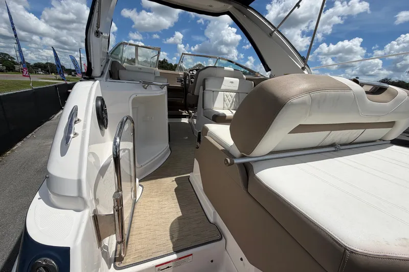 Slide: The Image of 2018 Regal 28 Express boat interior with seating and open cockpit under a sunny sky. - 16