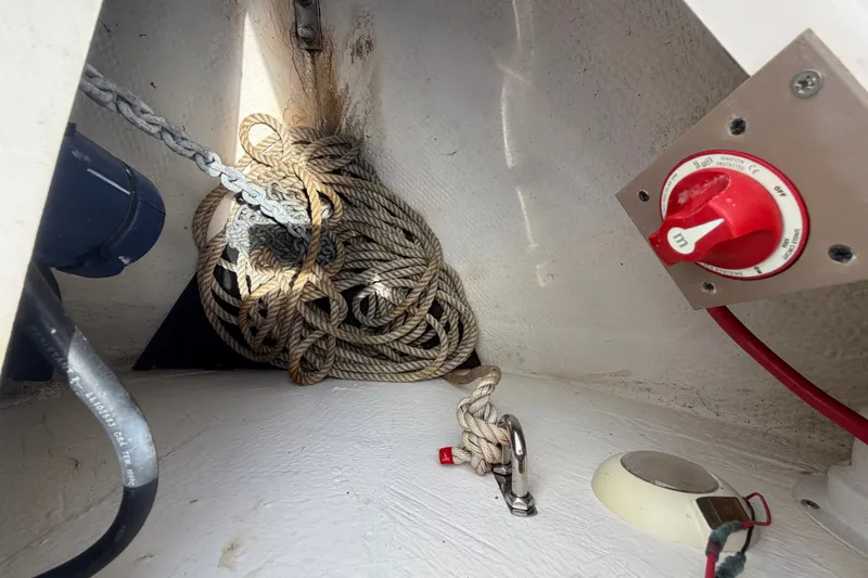 Slide: The Image of Anchor compartment of 2018 Regal 28 Express boat with ropes and control switch. - 50