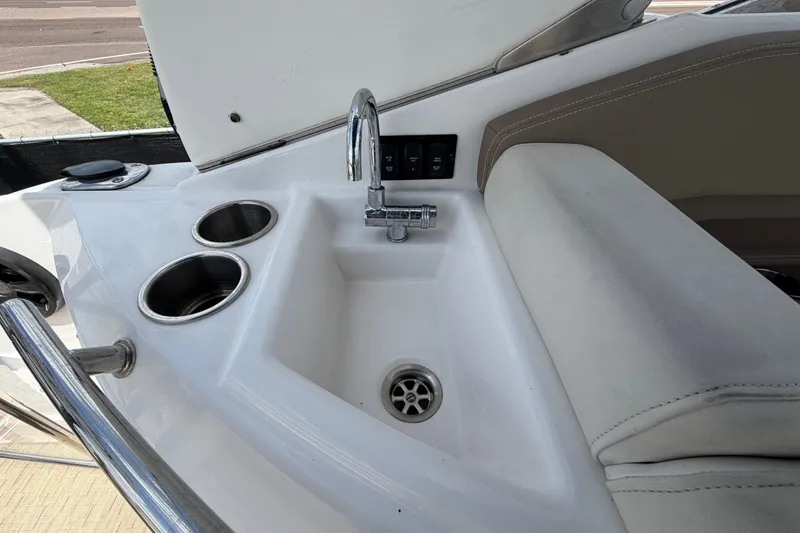 Slide: The Image of Cockpit sink and cup holders on 2018 Regal 28 Express boat. - 20