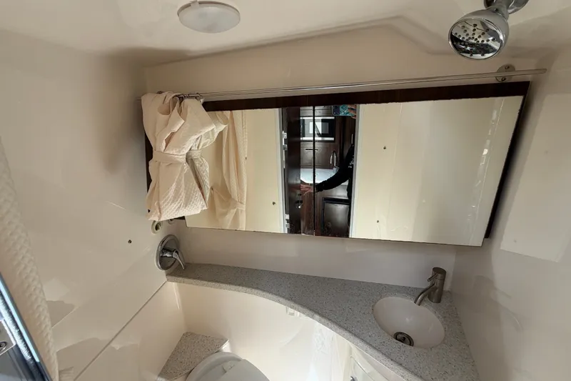 Slide: The Image of Bathroom interior of 2018 Regal 28 Express boat with mirror and sink. - 89