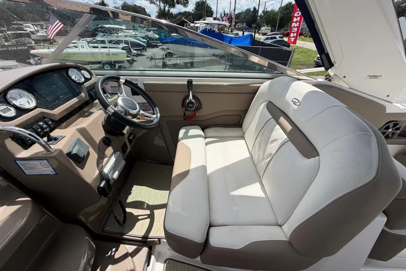 Slide: The Image of 2018 Regal 28 Express boat cockpit with steering wheel and seating area. - 33