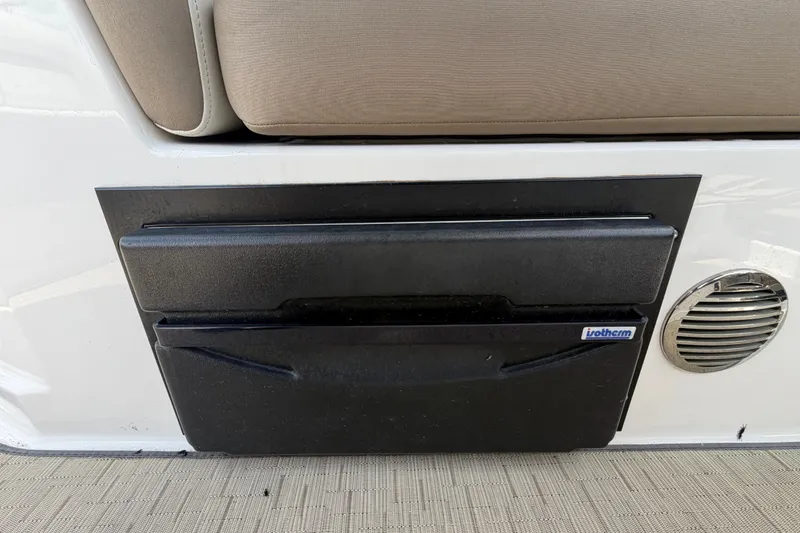Slide: The Image of Built-in cooler on 2018 Regal 28 Express boat with beige seating. - 26