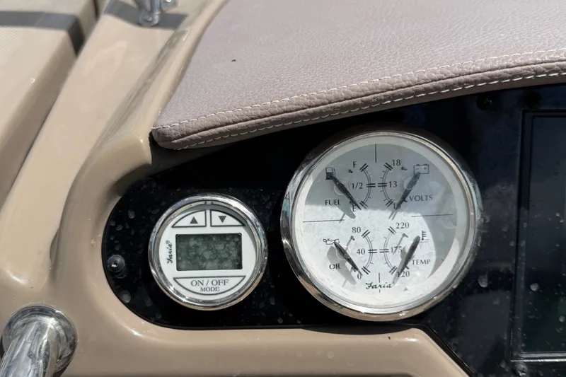Slide: The Image of Dashboard gauges of a 2018 Regal 28 Express boat, showing fuel, volts, oil, and temperature. - 36