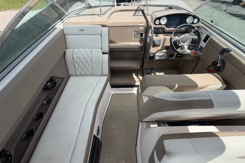 Slide: The Image of Interior of a 2018 Regal 28 Express boat, featuring seating and control panel. - 25