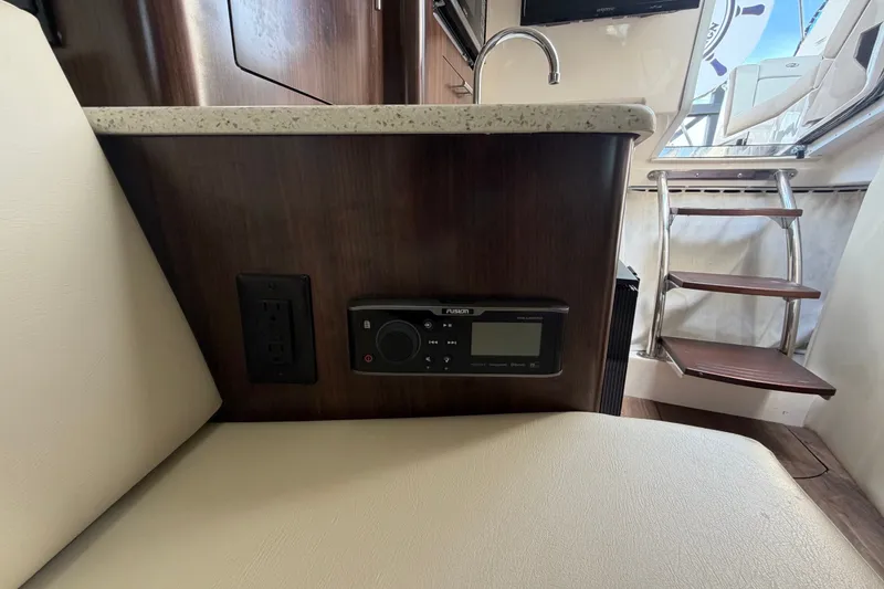 Slide: The Image of Interior of 2018 Regal 28 Express boat with audio system and stairs. - 83