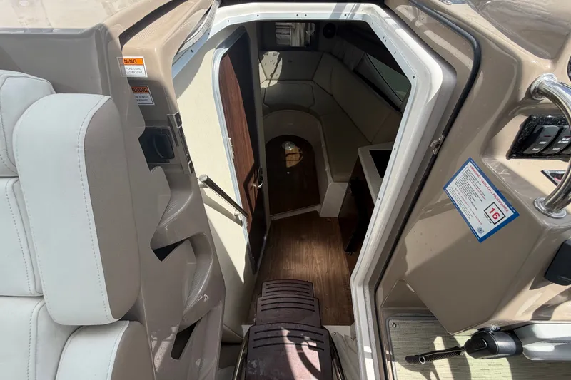 Slide: The Image of Interior view of 2018 Regal 28 Express boat, featuring seating and cabin entrance. - 54