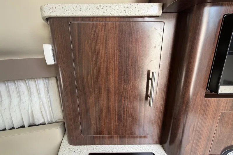 Slide: The Image of Wooden cabinet door with metal handle in 2018 Regal 28 Express boat interior. - 70