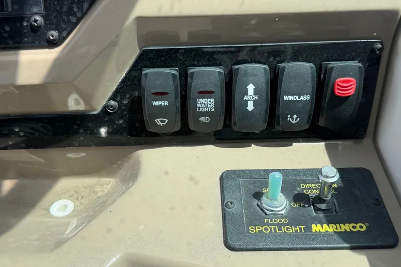 Slide: The Image of Control panel of a 2018 Regal 28 Express boat with various switches. - 38