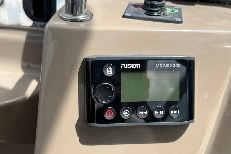Slide: The Image of Fusion MS-NRX300 marine stereo control on 2018 Regal 28 Express boat dashboard. - 41