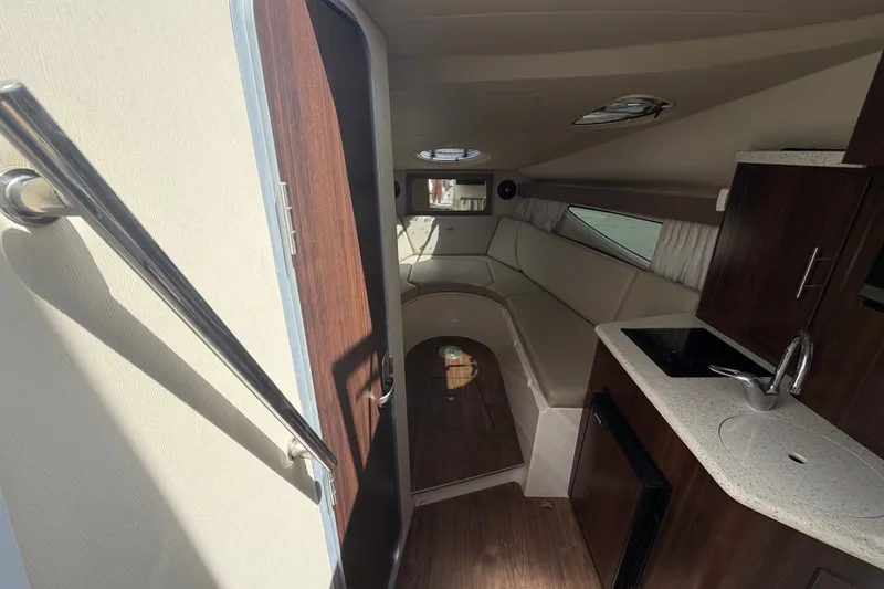 Slide: The Image of 2018 Regal 28 Express cabin interior with kitchenette and seating area. - 55