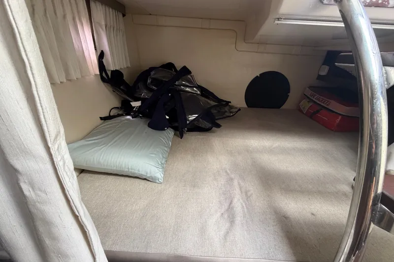 Slide: The Image of Interior cabin of 2018 Regal 28 Express boat with bedding and life jackets. - 92