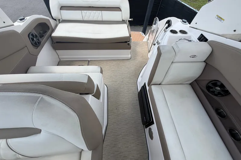 Slide: The Image of Interior of a 2018 Regal 28 Express boat with beige and white seating. - 98