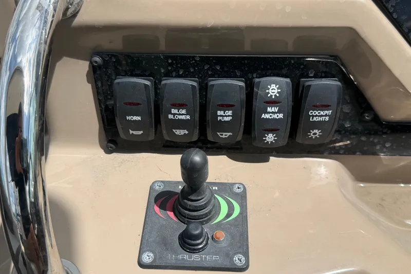 Slide: The Image of Control panel of a 2018 Regal 28 Express boat with switches and joystick. - 39