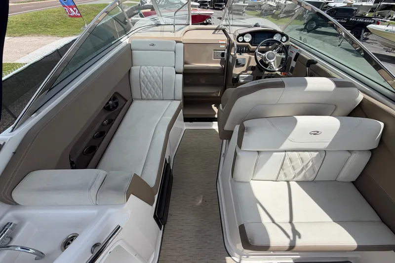 Slide: The Image of 2018 Regal 28 Express boat interior with seating and steering wheel. - 24