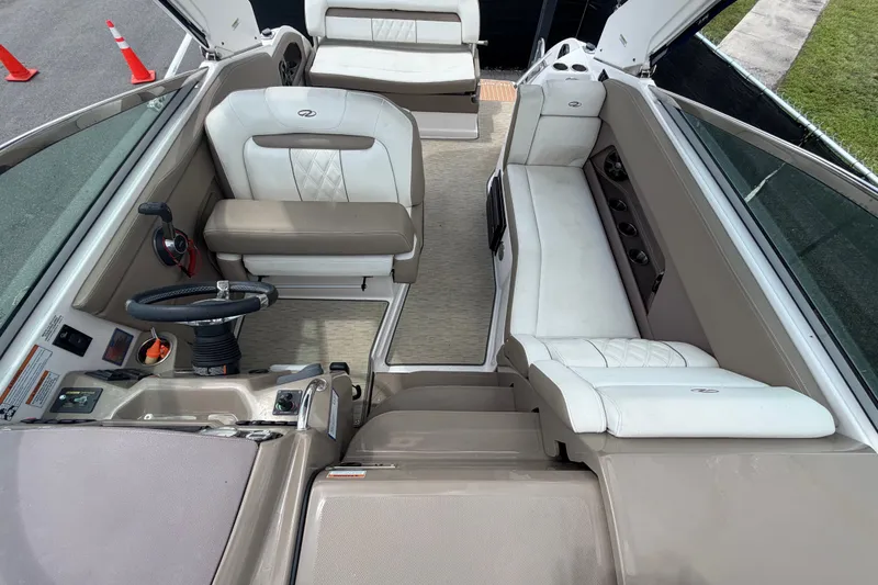 Slide: The Image of Interior of a 2018 Regal 28 Express boat with beige and white seating. - 53