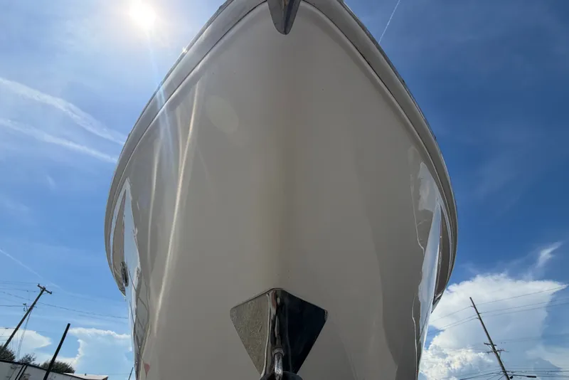 Slide: The Image of The 2018 Regal 28 Express displays its sleek white hull under a clear blue sky. - 13