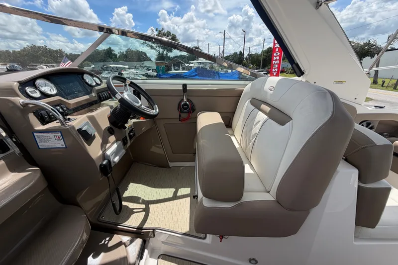 Slide: The Image of Interior of a 2018 Regal 28 Express boat, featuring steering wheel and seating. - 32