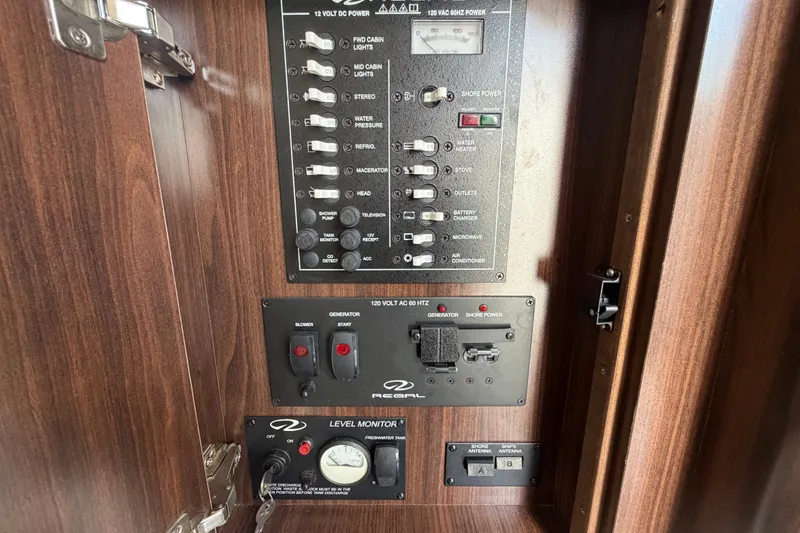 Slide: The Image of Control panel of a 2018 Regal 28 Express boat with switches and gauges. - 71