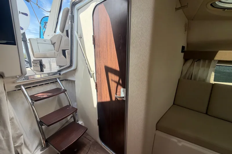 Slide: The Image of Interior of 2018 Regal 28 Express boat with stairs and seating area. - 86