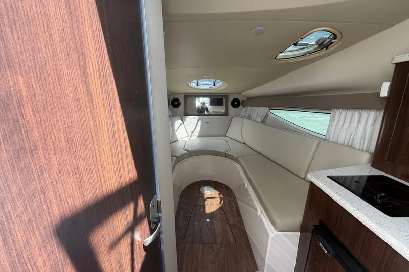 Slide: The Image of Interior of 2018 Regal 28 Express boat with seating and kitchenette. - 57