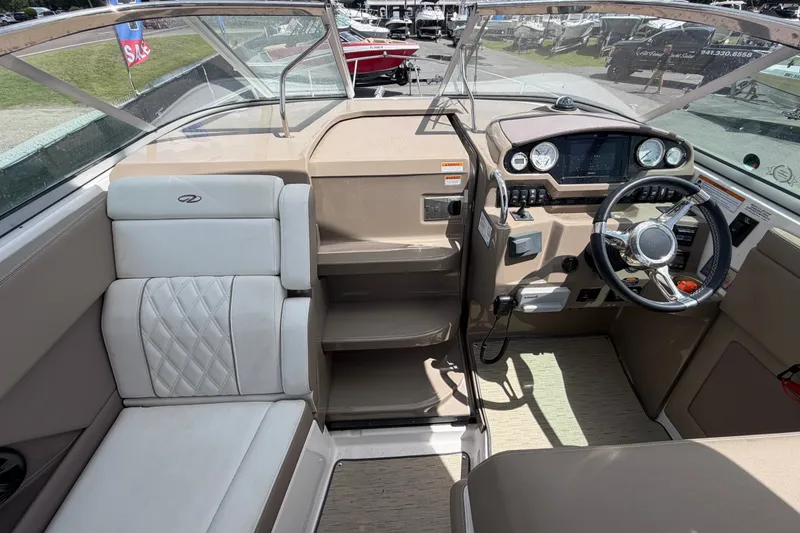 Slide: The Image of Interior view of a 2018 Regal 28 Express boat cockpit with steering wheel and seating. - 31