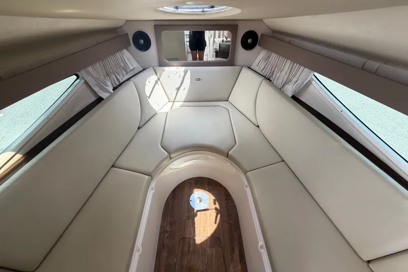 Slide: The Image of Interior cabin of 2018 Regal 28 Express boat with beige seating and wood flooring. - 79
