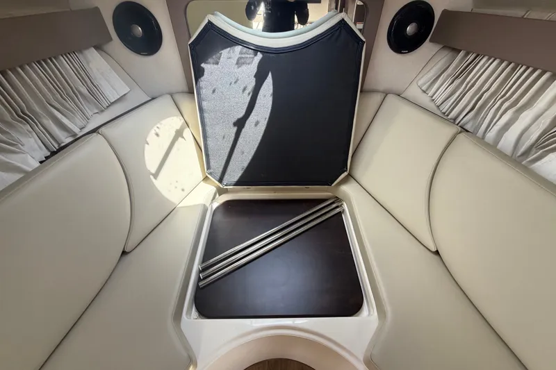 Slide: The Image of Interior cabin of a 2018 Regal 28 Express boat with beige seating and storage. - 76