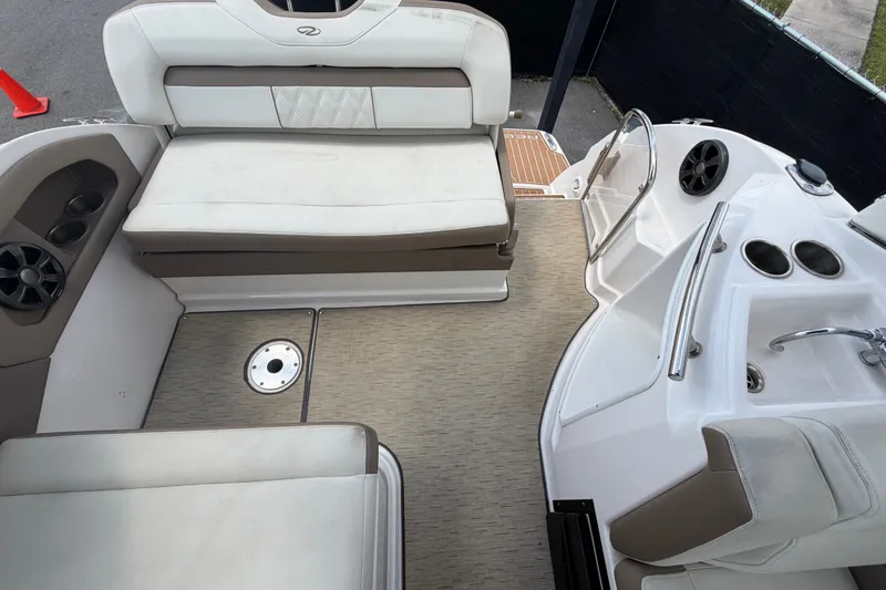 Slide: The Image of Interior of a 2018 Regal 28 Express boat with seating and cup holders. - 99
