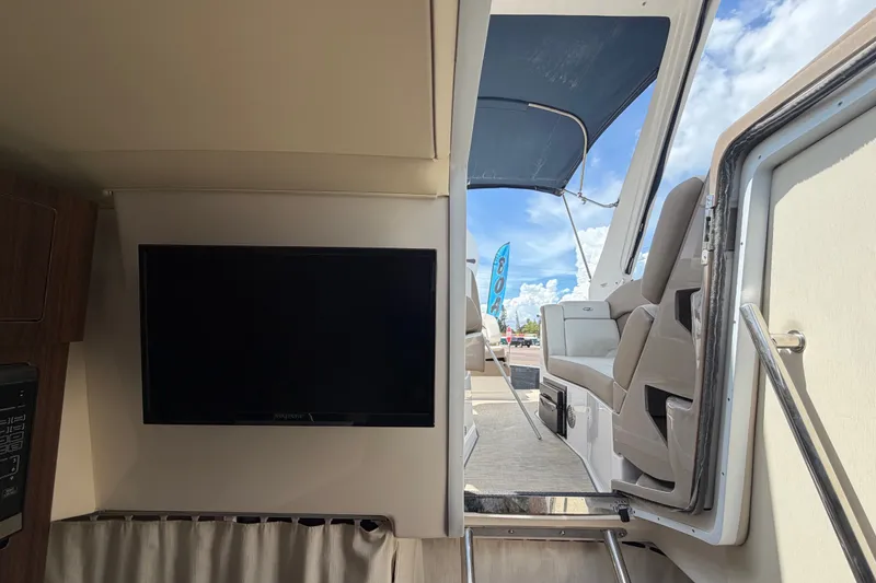 Slide: The Image of Interior view of 2018 Regal 28 Express boat with TV and seating area. - 95
