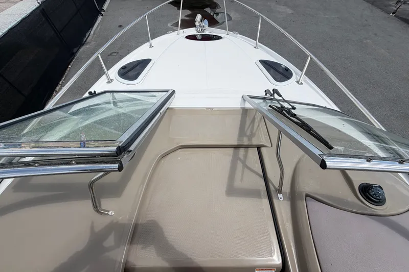 Slide: The Image of 2018 Regal 28 Express boat deck with open windshield and railing. - 45