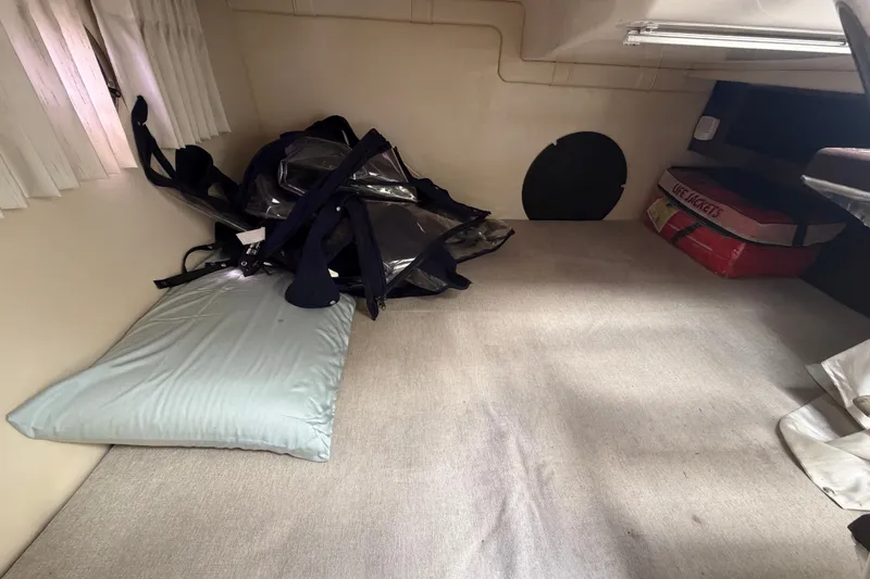 Slide: The Image of Interior cabin of 2018 Regal 28 Express with life jackets and bedding. - 93