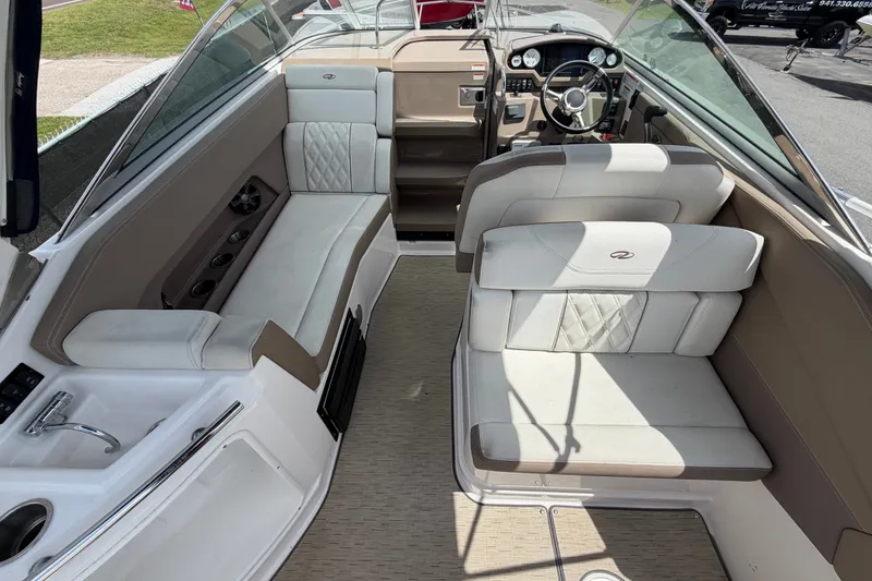 Slide: The Image of Interior of a 2018 Regal 28 Express boat with luxurious seating and steering area. - 18