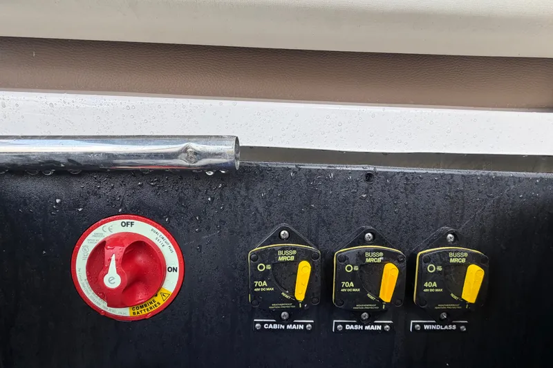 Slide: The Image of Control panel of a 2018 Regal 28 Express boat with switches and circuit breakers. - 30