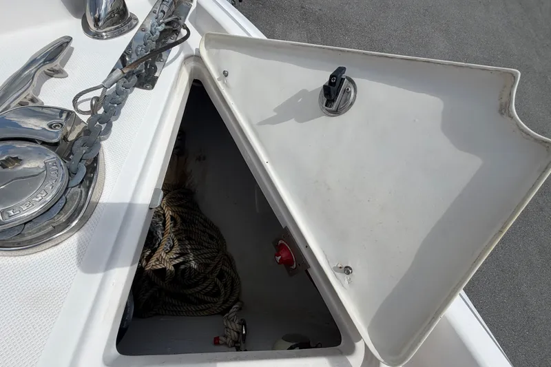 Slide: The Image of Open anchor locker on 2018 Regal 28 Express boat, showing chain and rope storage. - 49