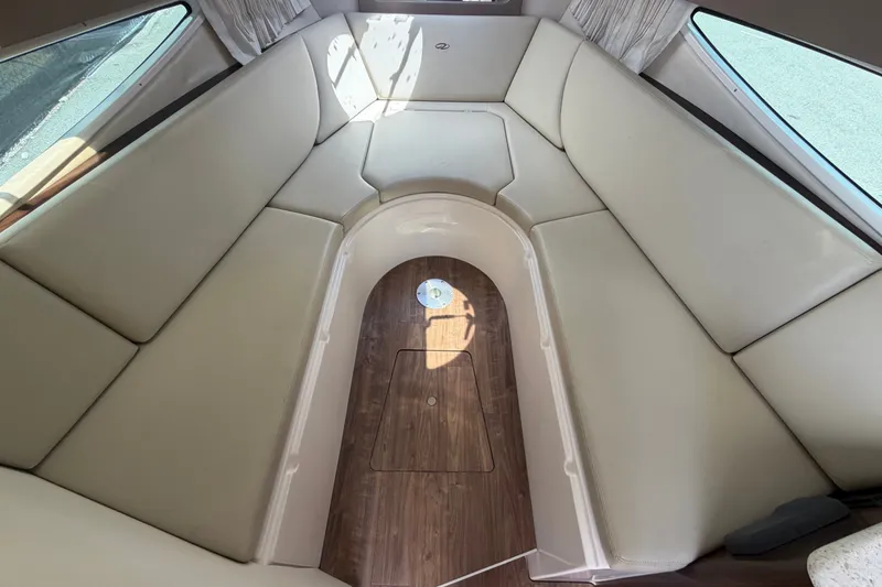 Slide: The Image of Interior of 2018 Regal 28 Express boat with beige seating and wood flooring. - 72