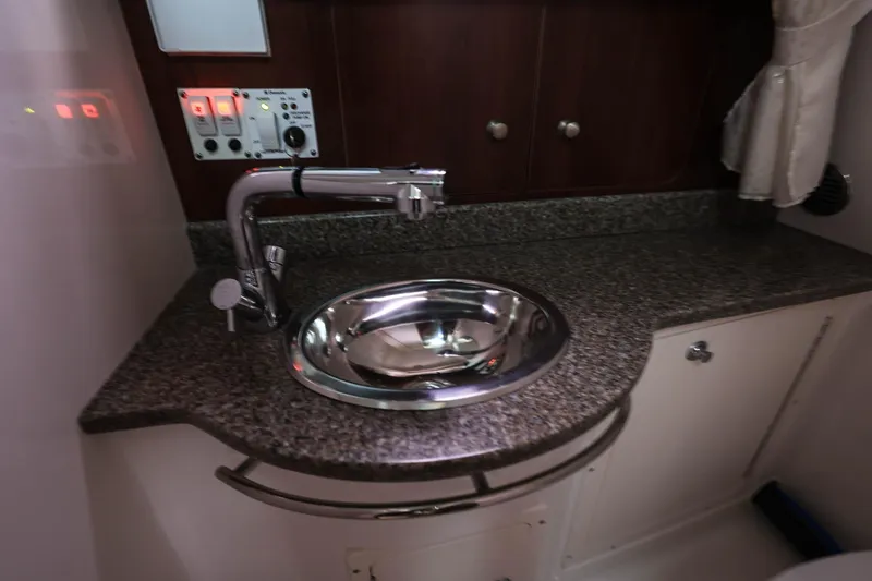 Slide: The Image of 2018 Robalo R305 Walkaround boat interior with granite countertop and stainless steel sink. - 29