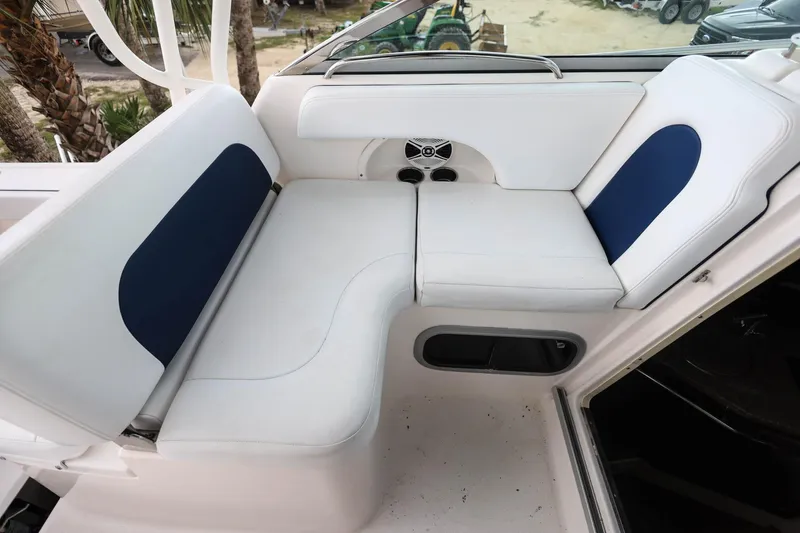 Slide: The Image of 2018 Robalo R305 Walkaround boat interior seating with white and blue cushions. - 22