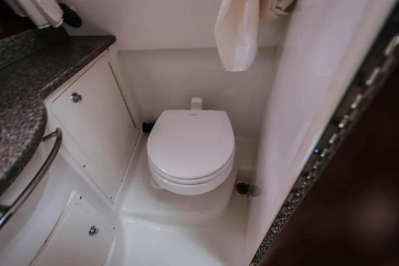 Slide: The Image of 2018 Robalo R305 Walkaround boat bathroom with toilet and countertop. - 30