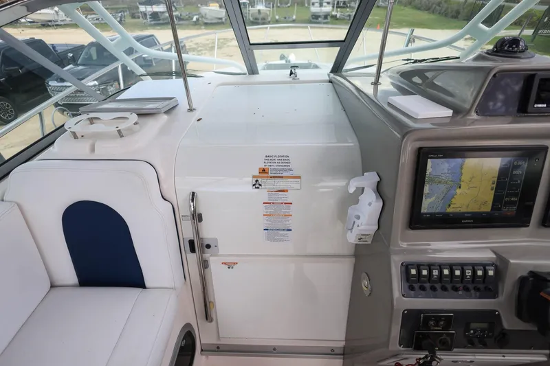 Slide: The Image of 2018 Robalo R305 Walkaround cockpit with navigation system and seating area. - 24